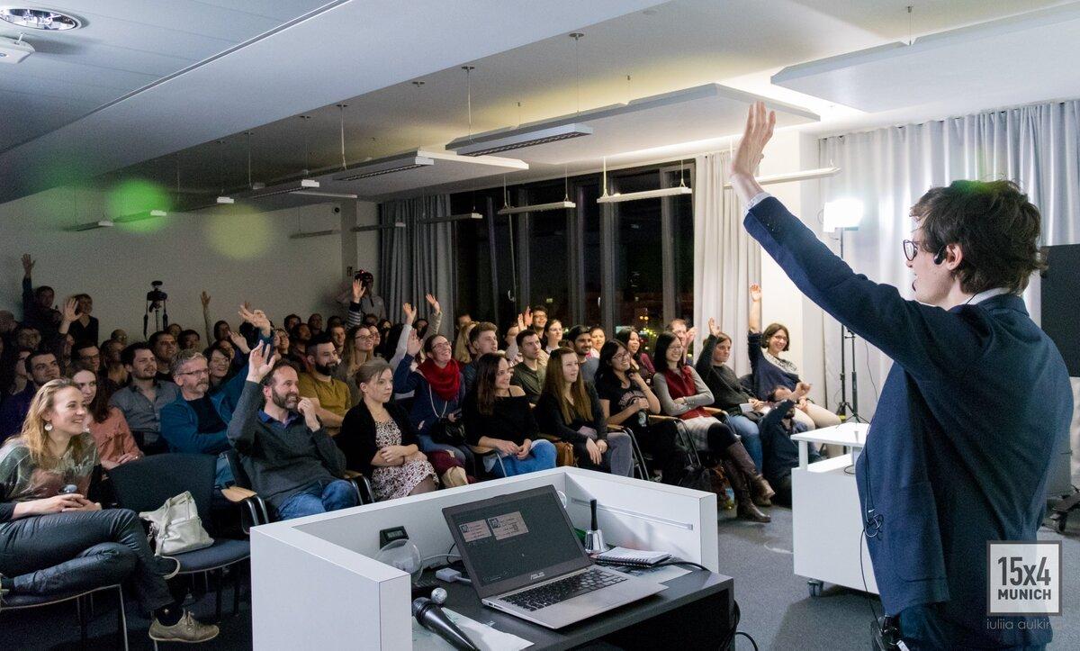 André speaking to a packed audience